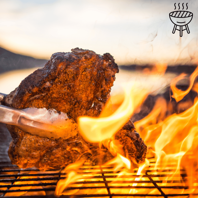 Burnt Ridge BBQ Rub, Roast cooking on BBQ getting picked up by tongs.