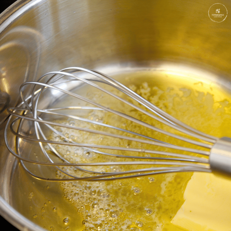 Melting butter in a bowl with a whisk