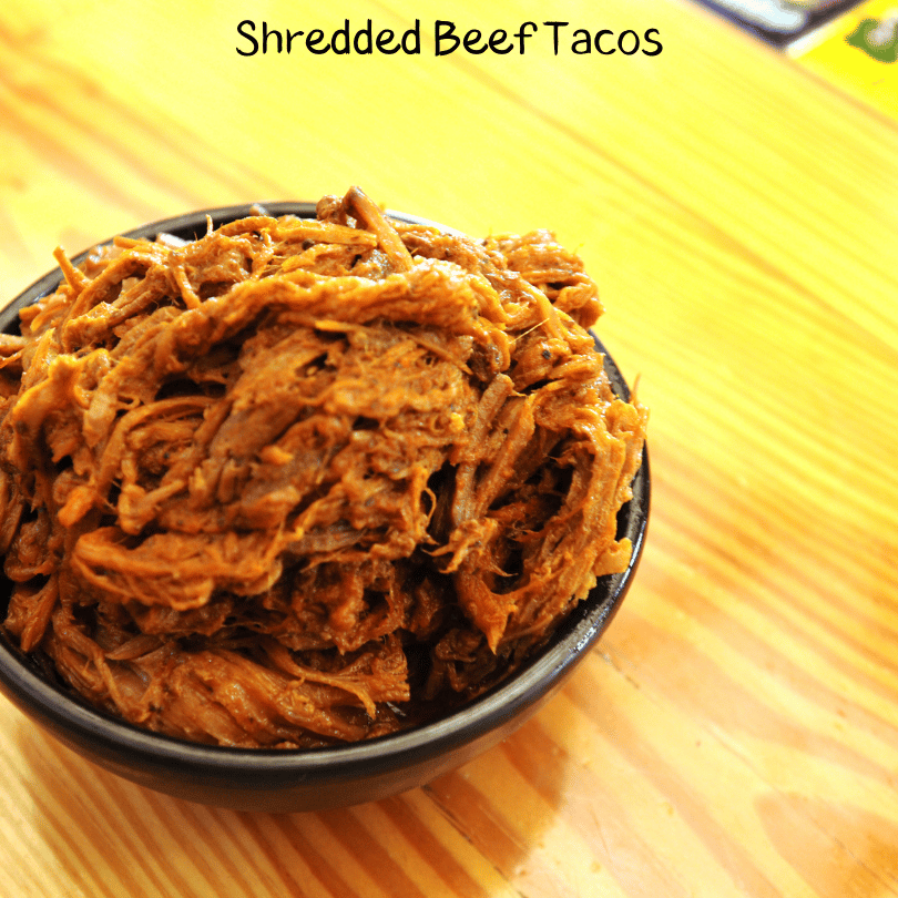 Shredded Beef in a bowl with the words Shredded Beef Tacos