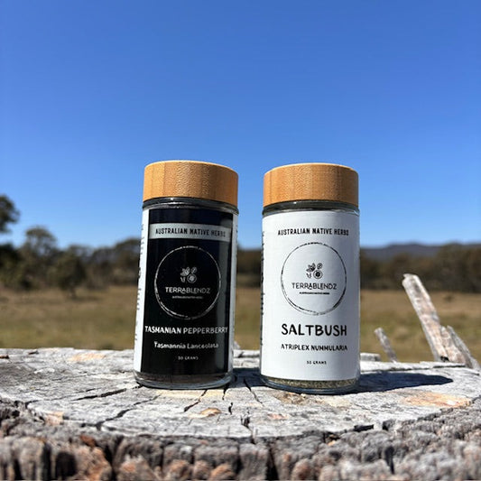 Jars of Saltbush & Pepperberry on a stump.