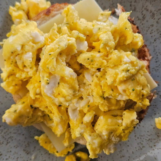 Native scrambled eggs on a bun with cheese.