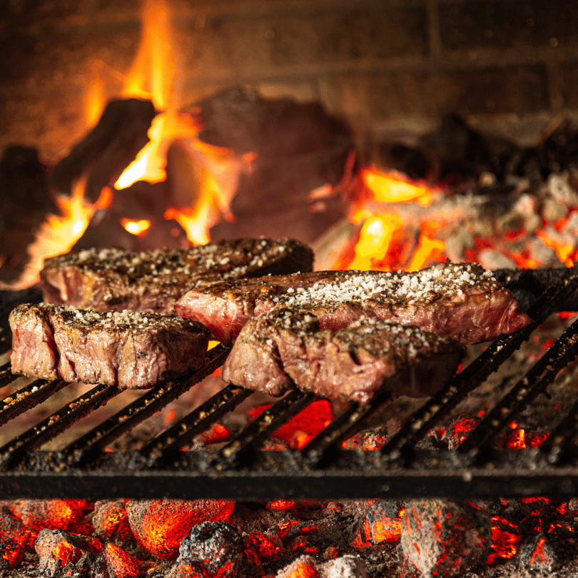 Terrablendz steak cooking on a grill with Bush Salt